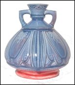 A  Royal Worcester pottery twin handled vase in the secessionist manner having flambe blue drip