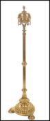 A 19th century brass tall oil lamp standard raised on a trefoil base with pad feet, turned reeded