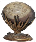 A late 19th century Australian gilt metal emu egg on stand. The stand with cast detailed lozenge