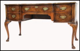 A 19th century Queen Anne revival  walnut writing table desk being raised on cabriole legs with
