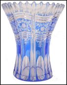 A late 19th century / early 20th century Bohemian blue glass vase of flared form being faced cut and