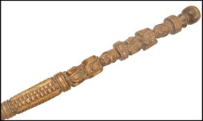 An early 20th century carved hardwood walking stick cane of Polynesian origin. Hand carved with