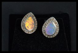 A pair of silver opal and CZ pear shaped earrings