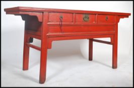 A 20th century large Chinese red lacquered sideboa