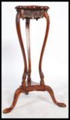 A vintage 20th century mahogany torchere plant sta