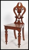 A 19th century mahogany armorial hall chair, the s
