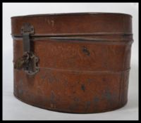 A 19th century Victorian tin hat box having a hing