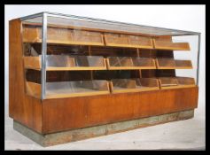 A mid 20th century light oak haberdashery shop dis