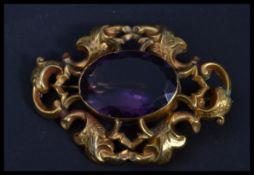 A yellow metal substantial amethyst brooch with ce