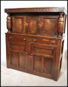 A 1930's oak court cupboard with upper cupboard, t