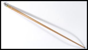 A 20th century walking stick cane having a taperin