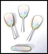 A silver and  guilloche Art Deco decorated enamel dressing table set, London assay and dating to