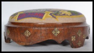 A 18th / 19th Century Georgian walnut footstool embossed with brass decoration and having a later