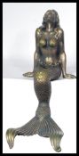 A bronzed effect cast metal large recumbent mermaid, in a seated position. Measures 45 cm high.