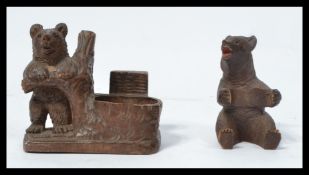 Two Blackforest Black Forest carved figurines of bears one in the form of an inkwell holder the