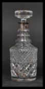 A hallmarked silver collared cut glass decanter having a faceted flat top stopper with tapered