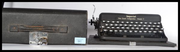 A vintage 20th century  cased portable Imperial Model T typewriter in a good working condition.