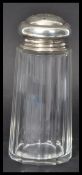 A silver hallmarked topped cut glass sugar sifter by EJ Houlston. The faceted glass body having star