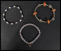 A group of three vintage bracelets to include a silver 925 Pandora example , a pink glass bead