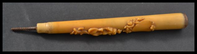 A 19th century Victorian parasol handle with applied floral carvings and heart. Amber type resin