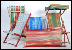 A collection of 20th Century vintage folding steamer lounger sun bed deck chairs, all with vibrant