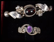 A Victorian silver and garnet set brooch along with a silver and amethyst ring.