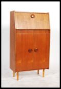 A 1970's retro teak wood cocktail drinks cabinet with metamorphic action mirror and decorative glass