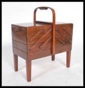 An early 20th century vintage metamorphic sewing box having cantilever action with lift up lid