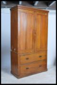 A George III style mahogany linen press the moulded cornice above a pair of panelled doors, two long