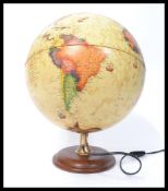 A vintage retro 20th century antique style desk top globe raised on a circular wooden base.