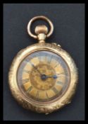 A continental 14k gold pocket watch. The gilt dial having Roman numeral chapter ring with faceted
