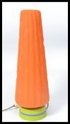 A retro 1960's table lamp having a striped green and blue lamp base with wonderful conical orange