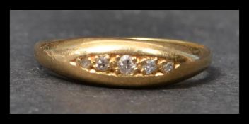 An early 20th century 18ct gold and diamond ring having 5 graduated old cut diamonds in a gypsy