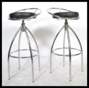 A pair of retro style barbers chairs / bar stools. Chrome pedestal adjustable bases surmounted