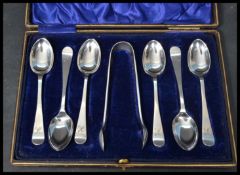 A set of six cased silver hallmarked tea spoons along with a pair of EPNS sugar tongs. Hallmarked