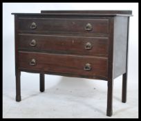 An early 20th Century Edwardian chest of three long drawers, raised on square supports.