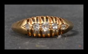 An early 20th century 18ct gold and diamond ring having 5 graduated old cut diamonds in a gypsy