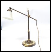A vintage retro 20th century industrial brass anglepoise type lamp raised on a stepped circular base