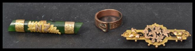 A 9ct gold hallmarked buckle ring Size L, weight 3.1g together with a Jade and gold brooch and a