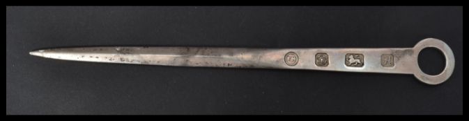 A hallmarked silver letter opener formed as a meat skewer with feature hallmarked for Sheffield