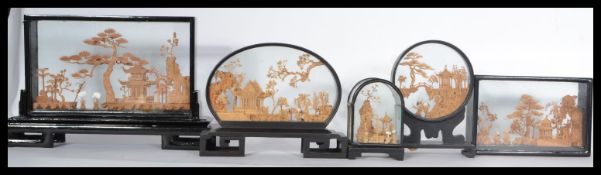 A group of five Chinese cork work diorama model displays of pagodas , trees , storks etc held within