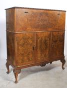 A vintage Maple & Co 1930's walnut 20th Century Art Deco cocktail cabinet, drop centre cocktail