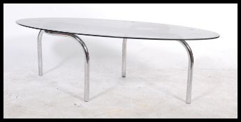 A 20th Century Italian retro industrial smoked glass coffee table having an ovoid shaped glass above