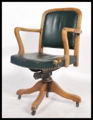 A vintage early 20th century industrial 1930's swivel chair raised on a quadruped swivel base with