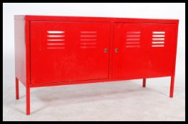 A vintage retro style metal tool cabinet / sideboard, two swing doors raised on square legs finished