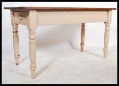 A shabby chic up-cycled farmhouse dining table single draw to one end raised on turned painted