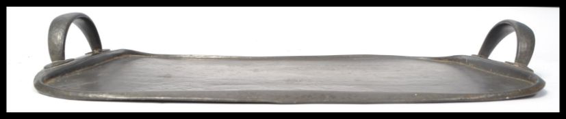 A Tudric pewter twin handled tea tray of rounded rectangular form after design by Archibald Knox,