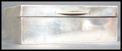 An early 20th century silver hallmarked cigarette box humidor having an engine turned design with