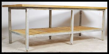 A large planked topped industrial metal framed table, the planked top being constructed from