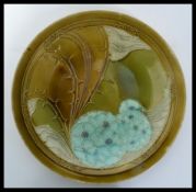 An early 20th century Minton ' Secessionist Ware ' dish cabinet plate dated 1917 designed by Léon